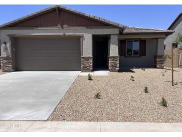 Charming single-story home with desert landscaping, a two-car garage, and a welcoming front porch at 20612 N 226Th Dr, Surprise, AZ 85387
