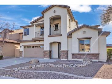 Two-story house with stone accents and a two-car garage at 2327 W Branham Ln, Phoenix, AZ 85041