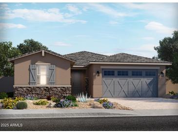 Single-story home with gray garage doors and stone accents at 24604 W Grenadine Rd, Buckeye, AZ 85326