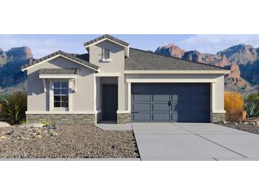 One-story home with gray garage door and stone accents at 27256 N 74Th Ln, Peoria, AZ 85383