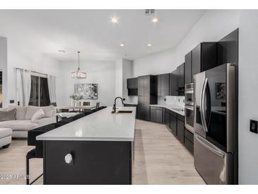 Modern kitchen with large island, stainless steel appliances, and white quartz countertops at 2742 S Jacob St, Gilbert, AZ 85295