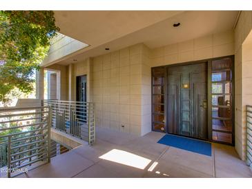 Modern entryway with a sleek, dark-colored door and a tiled floor at 2802 E Camino Acequia Dr # 36, Phoenix, AZ 85016