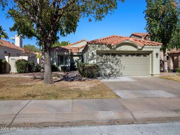 Single-story home with Spanish-style tile roof and attached two-car garage at 4142 E Sahuaro Dr, Phoenix, AZ 85028