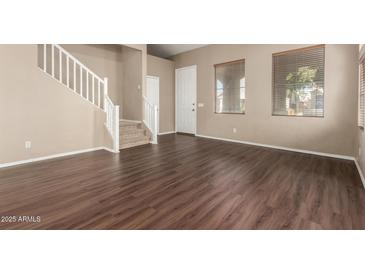 Living room with hardwood floors and a staircase at 5331 E Holmes Ave, Mesa, AZ 85206