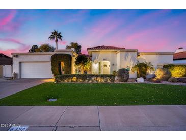 Charming single-story home with lush landscaping, arched entry, and a two-car garage at 6320 E Kings Ave, Scottsdale, AZ 85254