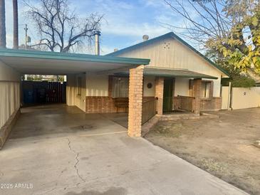 Brick home with carport and landscaped yard at 1006 E Pasadena Ave, Phoenix, AZ 85014