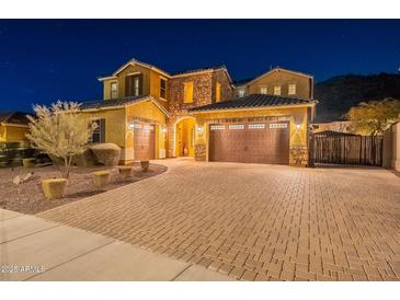 Stunning two-story home with a brick facade and three-car garage at 10110 W Redbird Rd, Peoria, AZ 85383