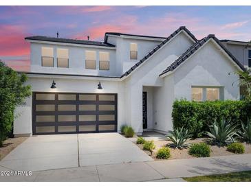 Two-story home with modern facade, landscaped yard, and two-car garage at 10150 E Thistle Ave, Mesa, AZ 85212