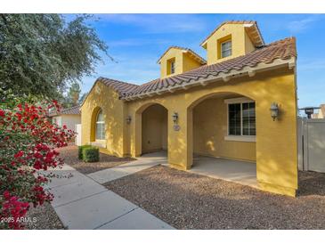 Attractive yellow two-story house with a welcoming front porch at 1161 S Storment Ln, Gilbert, AZ 85296