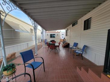 Covered patio with seating area, perfect for outdoor dining and relaxation at 1494 W Pawnee Ave, Apache Junction, AZ 85119