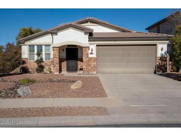 Single-story home with a two-car garage and landscaped front yard at 17680 W Lilac St, Goodyear, AZ 85338