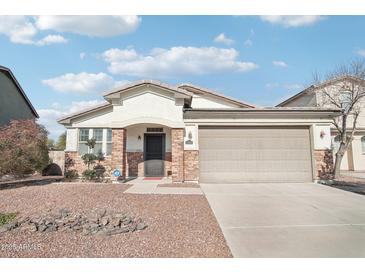 One-story home with a two-car garage and desert landscaping at 17680 W Lilac St, Goodyear, AZ 85338