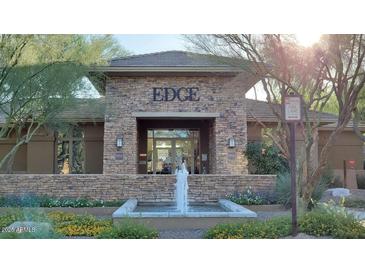 Attractive building exterior with stone accents and a water fountain at 20100 N 78Th Pl # 1092, Scottsdale, AZ 85255