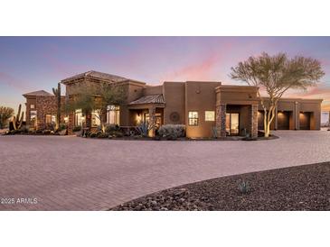 Elegant single-story home with a large driveway and beautifully landscaped grounds at 30014 N Baker Ct, Scottsdale, AZ 85262