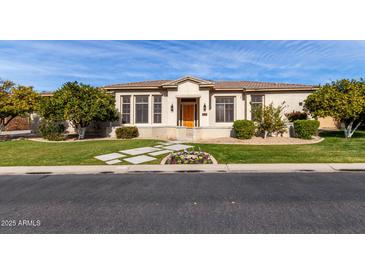 One-story home with landscaped yard and walkway at 3326 E Ivyglen Cir, Mesa, AZ 85213