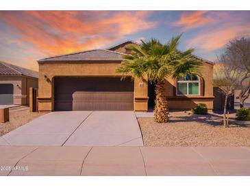 Charming single-story home boasts a well-maintained front yard, and a spacious two-car garage at 41838 W Chatham Pl, Maricopa, AZ 85138