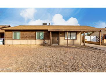 Ranch style home with a covered entry and spacious front yard at 5932 W Holly St, Phoenix, AZ 85035