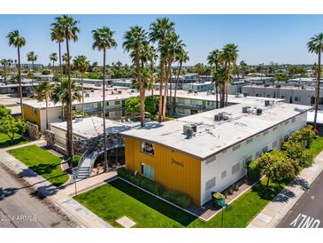 Aerial view of a mid-century modern apartment building with a pool and lush landscaping at 6805 E 2Nd St # 17, Scottsdale, AZ 85251