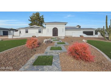 Stunning contemporary home with landscaped front yard and attractive walkway at 6912 E Larkspur Dr, Scottsdale, AZ 85254