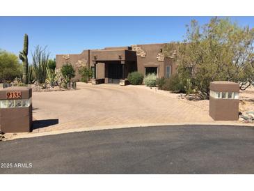 Stunning desert home with a large courtyard and gated entry at 9135 E Buckskin Trl, Scottsdale, AZ 85255