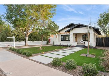 Updated craftsman home with artificial turf and walkway at 929 E Granada Rd, Phoenix, AZ 85006