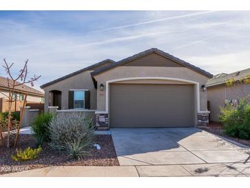 Single-story home with a two-car garage and desert landscaping at 9447 W Glenrosa Ave, Phoenix, AZ 85037