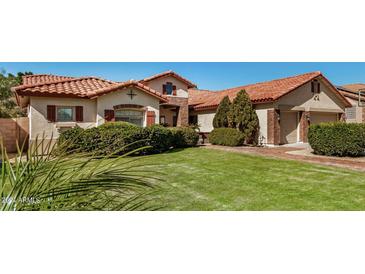 Beautiful home with tile roof, landscaped yard, and two-car garage at 9524 W Running Deer Trl, Peoria, AZ 85383