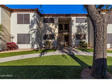 Attractive exterior of a condo building with landscaping and walkway at 9990 N Scottsdale Rd # 2048, Paradise Valley, AZ 85253