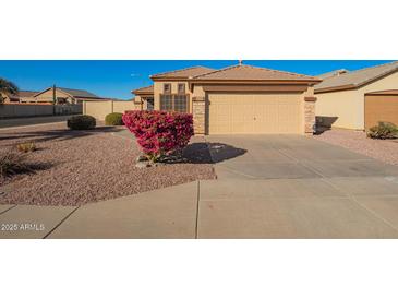 House exterior with attached garage and landscaping at 13370 W Port Au Prince Ln, Surprise, AZ 85379