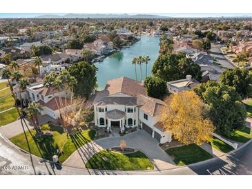 Luxury waterfront home with expansive lake views and circular driveway at 1519 E Treasure Cove Dr, Gilbert, AZ 85234