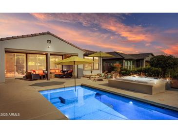 Stunning backyard oasis with a pool, spa, and patio furniture at 17535 E Silver Sage Ln, Rio Verde, AZ 85263