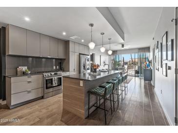 Modern kitchen with stainless steel appliances and island at 2300 E Campbell Ave # 102, Phoenix, AZ 85016