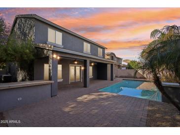 Stunning backyard with a refreshing pool, covered patio, and beautiful sunset views perfect for outdoor entertaining at 4188 E Lexington Ave, Gilbert, AZ 85234