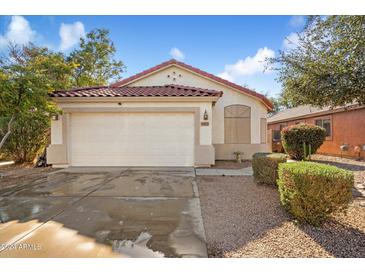 House exterior featuring a two-car garage and well-maintained landscaping at 45513 W Sky Ln, Maricopa, AZ 85139