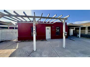 Charming red house with white pergola and address number 5543 at 5543 W Gardenia Ave, Glendale, AZ 85301