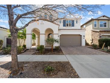 Two-story house with arched entryway and attached garage at 10713 E Hawk Ave, Mesa, AZ 85212