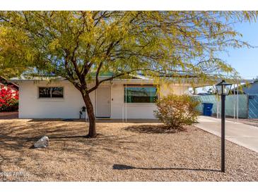 White single story home with a landscaped front yard and a covered entryway at 1121 S Lawther Dr, Apache Junction, AZ 85120