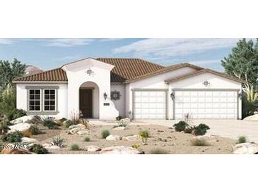 New home exterior with Spanish tile roof and two-car garage at 12316 W Parkway Ln, Avondale, AZ 85323