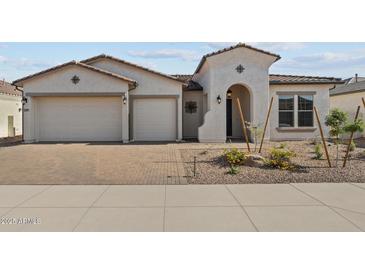 Charming single-story home with a three-car garage and well-maintained desert landscaping at 12316 W Parkway Ln, Avondale, AZ 85323