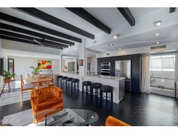 Modern kitchen with stainless steel appliances and breakfast bar at 1308 E Gardenia Dr, Phoenix, AZ 85020