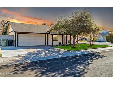 Single story home with attached garage and well-manicured lawn at 14821 N 60Th Dr, Glendale, AZ 85306