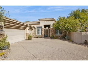 Craftsman style home with stone accents and a two-car garage at 15548 E Jojoba Ln, Fountain Hills, AZ 85268