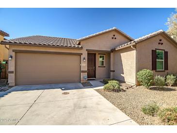 Single-story home with a two-car garage and landscaped front yard at 16224 W La Ventilla Way, Goodyear, AZ 85338