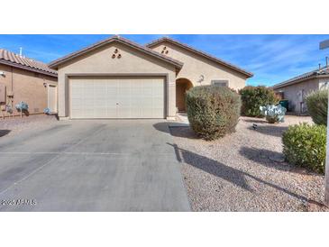 One-story house with a two-car garage and well-maintained landscaping at 18489 N Davis Dr, Maricopa, AZ 85138