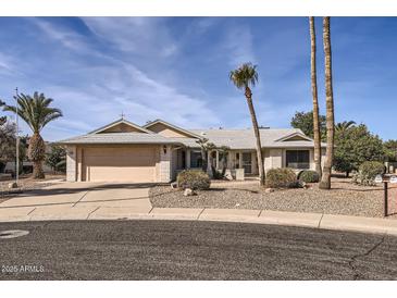 Single-story home with a two-car garage and desert landscaping at 18606 N Iona Ct, Sun City West, AZ 85375