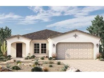 One-story home with Spanish-style architecture, two-car garage, and desert landscaping at 19320 W Missouri Ave, Litchfield Park, AZ 85340