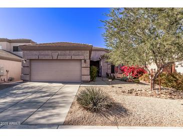 Single-story home with desert landscaping and a two-car garage at 26818 N 66Th Ln, Phoenix, AZ 85083