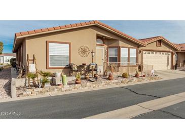 Inviting single-story home with landscaped front yard and two-car garage at 3301 S Goldfield Rd # 5027, Apache Junction, AZ 85119