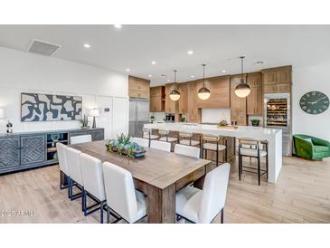 Open kitchen features a large island, custom cabinetry, and breakfast area at 40715 N Lytham Ct, Anthem, AZ 85086