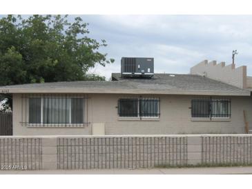 Tan single story home with security bars on windows and a block wall at 4142 E Moreland St # 2, Phoenix, AZ 85008